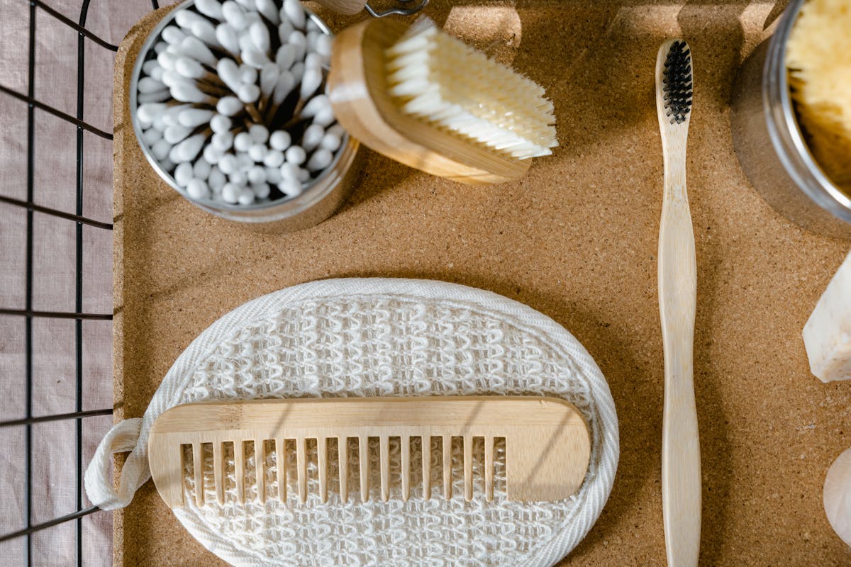9 Items You Should Never Sell at a Garage Sale 4 Eco-friendly wooden bathroom essentials including comb, toothbrush, and brush in a flat lay.
