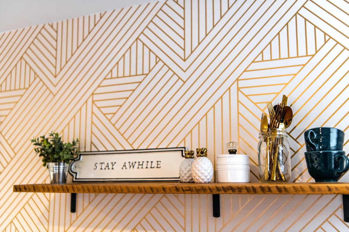 10 Home Features That Are Actually Turning Buyers Away in 2026 3 Elegant shelf with cups, decor, and a stylish geometric wall design. Perfect for modern interior inspiration.