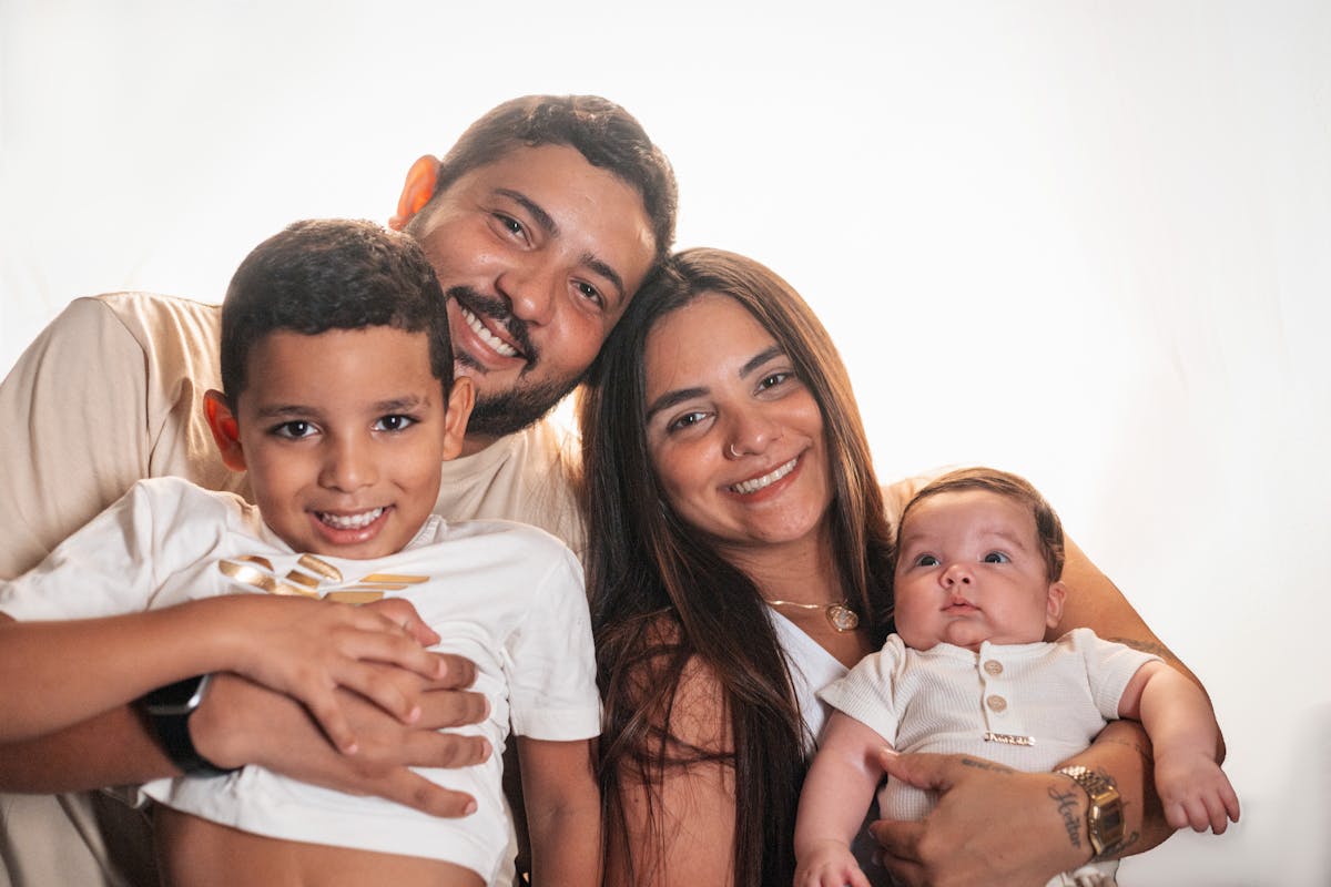 10 Costly Will Mistakes That Can Leave Families in Chaos 4 Joyful family portrait featuring smiling parents with their young children.
