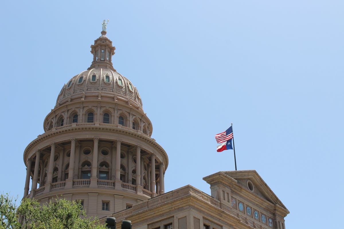 Top 10 Worst States in The US for Middle-Class Taxpayers 2 Low angle view of the Texas State Capitol dome and flags in Austin, Texas.