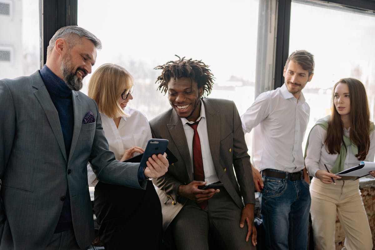 Don't Let the Recession Take You by Surprise: 10 Essential Strategies for Financial Survival 4 Multicultural team enjoying a light moment and collaboration in the office.