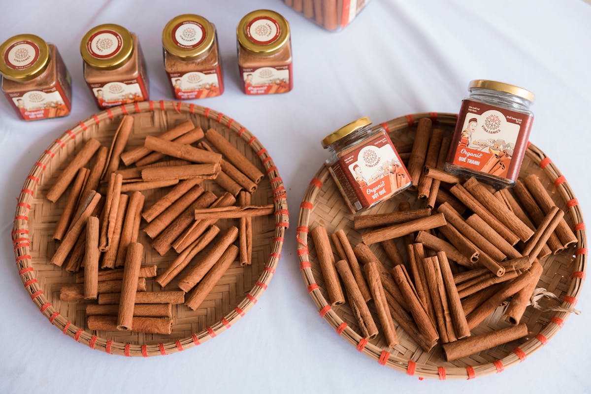 10 Everyday Foods That Could Be Toxic or Even Deadly 1 Organic cinnamon sticks arranged in woven trays alongside cinnamon jars, ideal for product packaging.