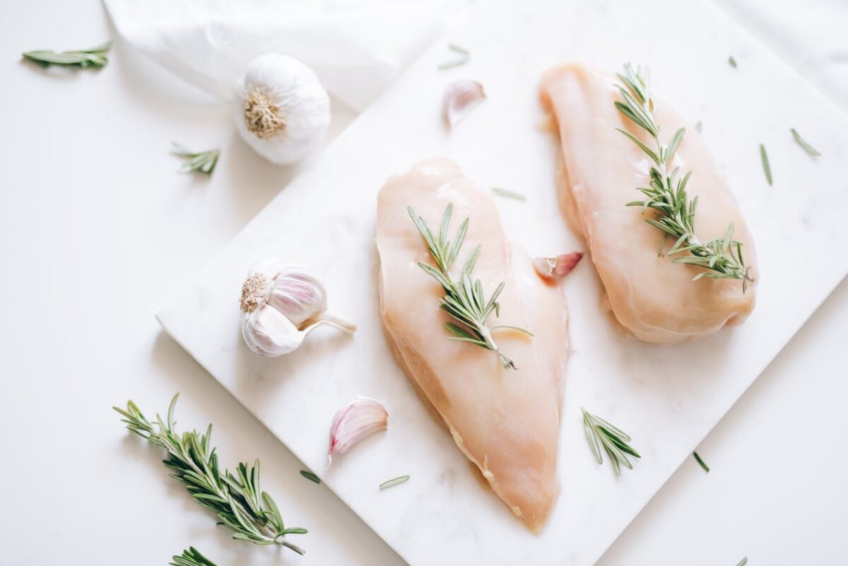 8 Common Mistakes You're Making by Skipping the Resting Step After Cooking Meat 2 /top-view-of-rosemary-sprigs-on-raw-chicken-breasts