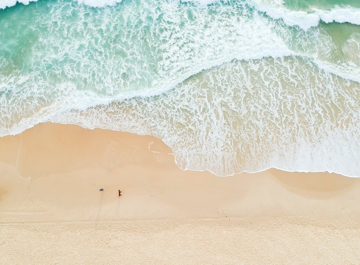 8 of the Most Unusual Things Ever Stolen 2 Serene aerial view of Castaways Beach in Queensland with gentle waves and sandy shores.