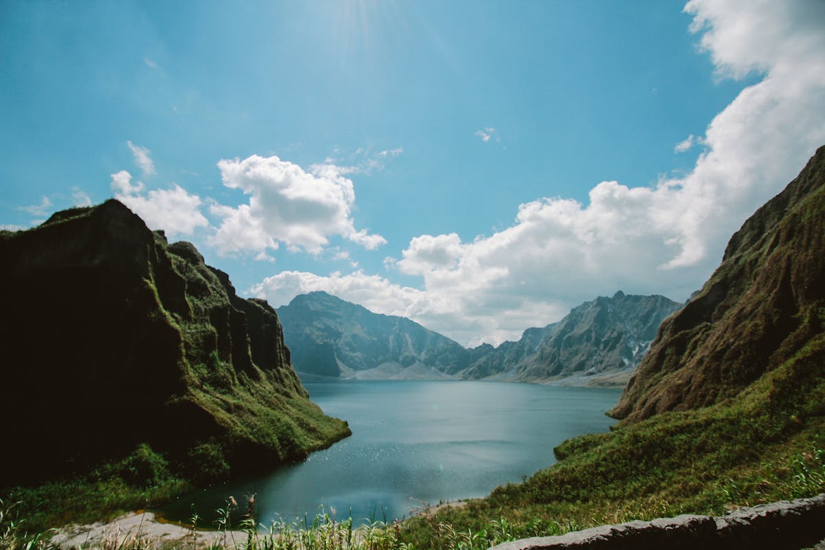 The 10 Most Dangerous Hikes in the World 4 Stunning landscape of Mt. Pinatubo's tranquil crater lake under a bright blue sky.