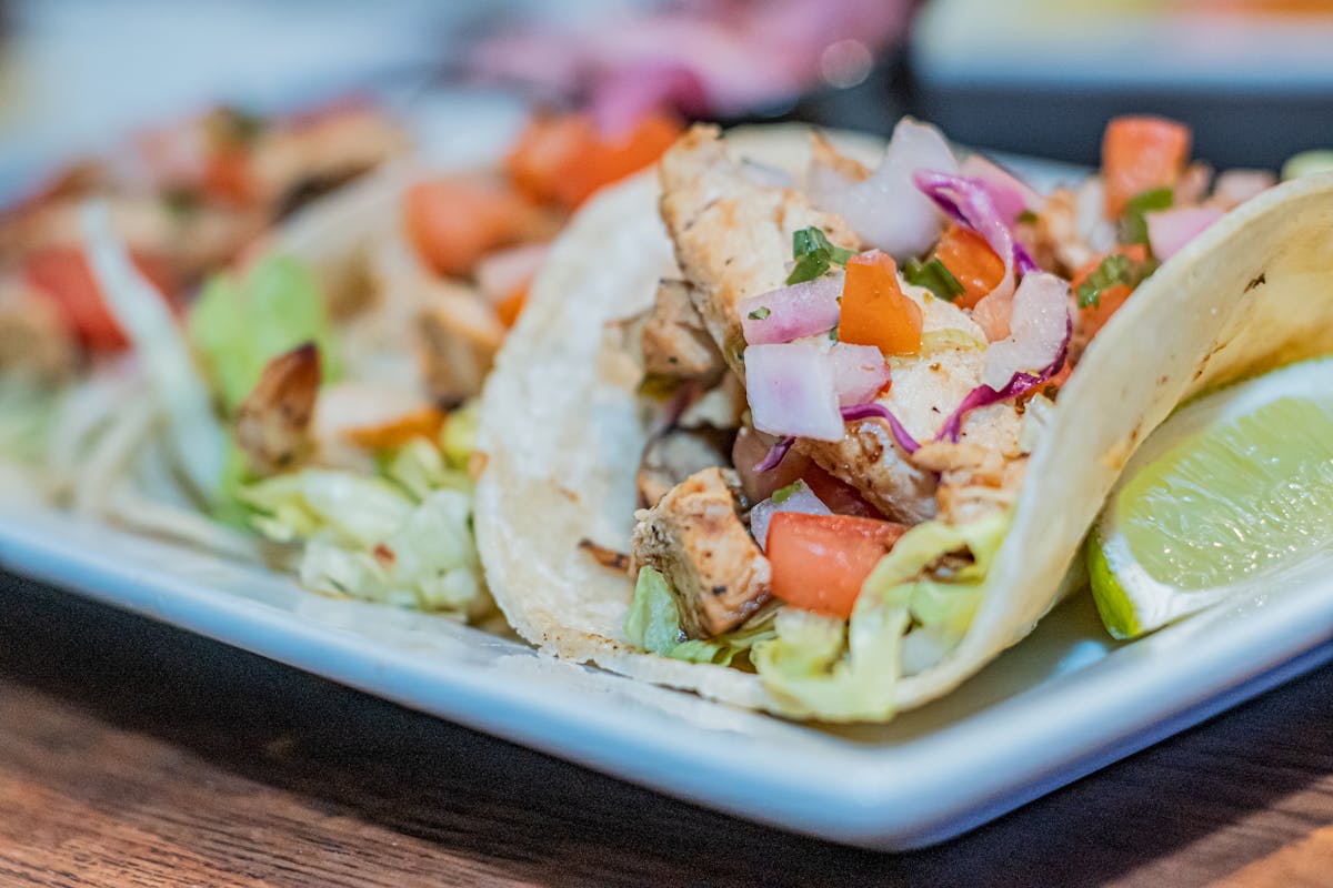 If You’re Still Ordering Takeout, You’re Missing These 9 Cheap Dinners 4 Tantalizing close-up of mouthwatering chicken lime tacos, perfect for food lovers.
