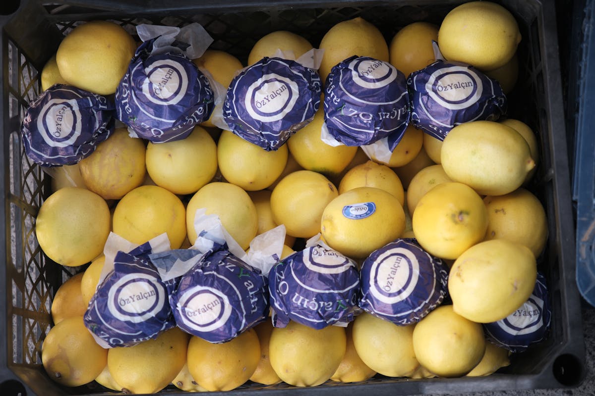 The 9 Most Outrageous Correlations You’ve Never Heard Of 3 Top view of fresh lemons in a crate at a market. Some lemons are wrapped.