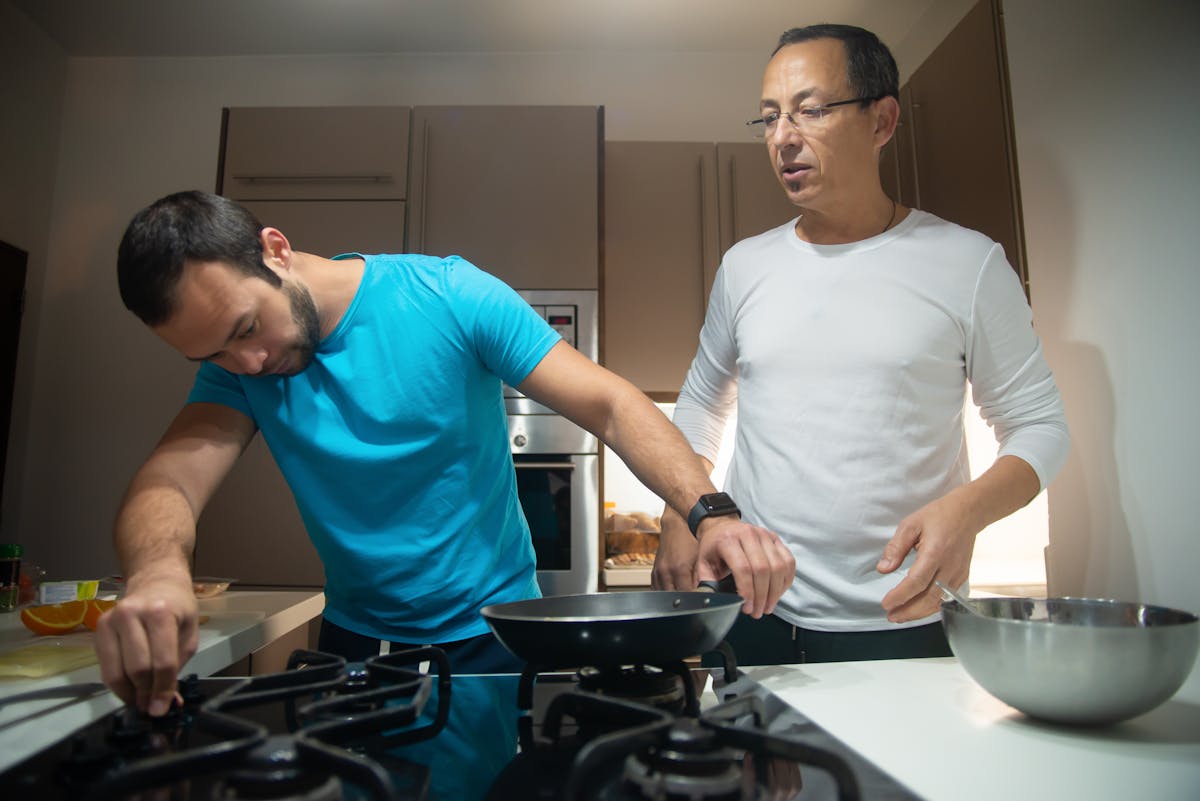 10 Bizarre Phobias That Will Leave You Stunned 1 Two men cooking together in a modern kitchen, fostering connection and teamwork.