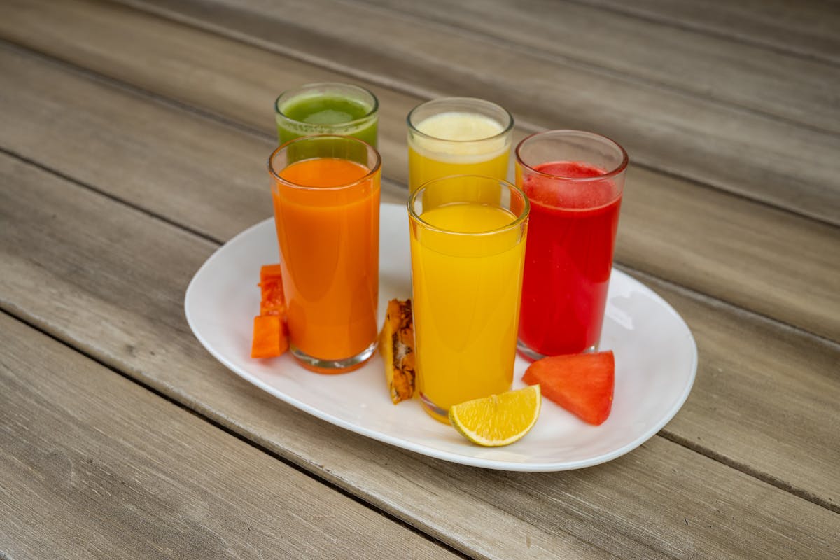 7 Sugary Drinks That Are Sabotaging Your Health 3 Vibrant assorted fruit juices served on a plate with fresh fruits in Salamanca.