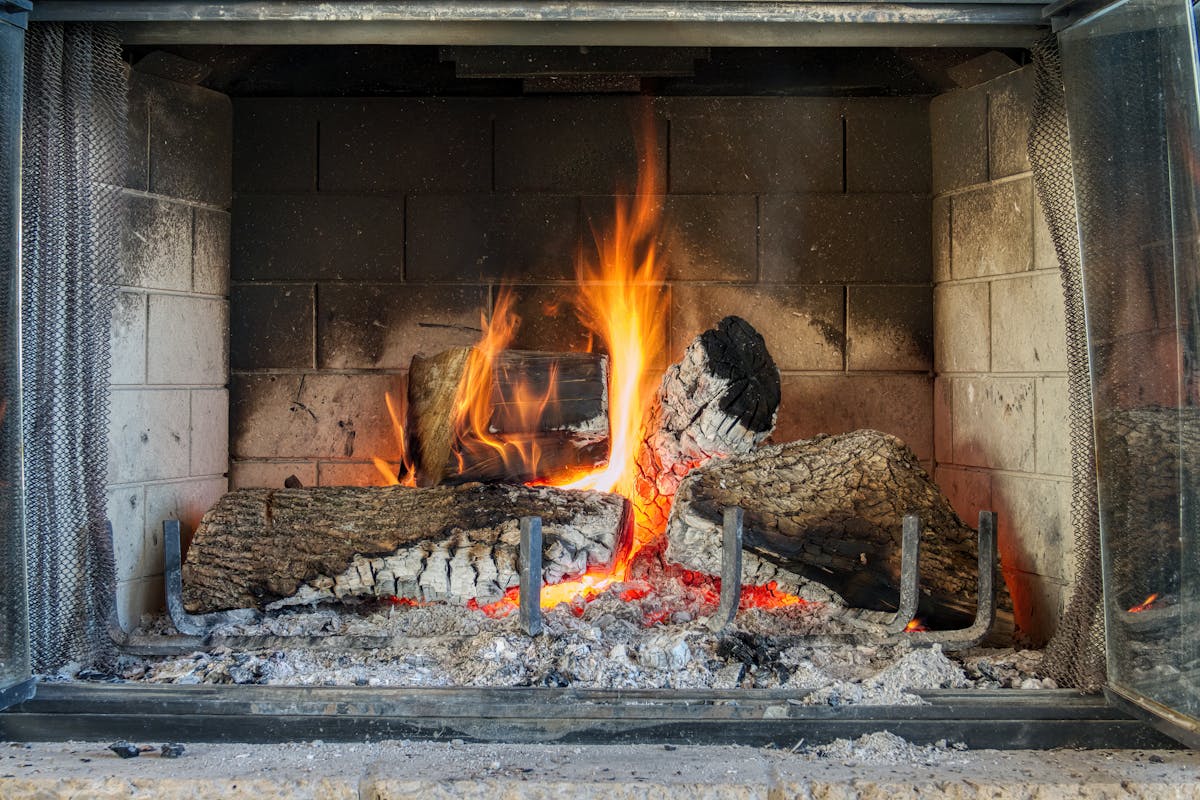 10 Weird Things Governments Actually Taxed 3 Warm and cozy fireplace with logs burning bright, providing warmth indoors.