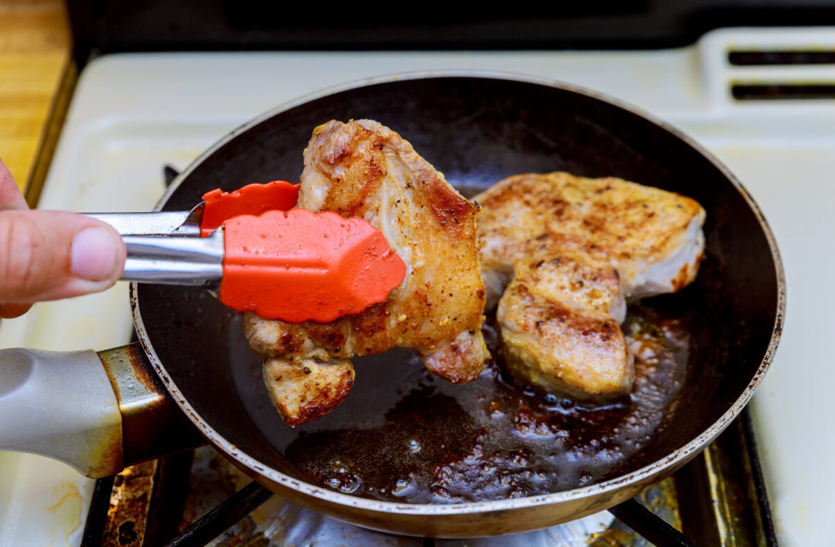 Pork steak chop with clary in frying pan grill closeup fry steak