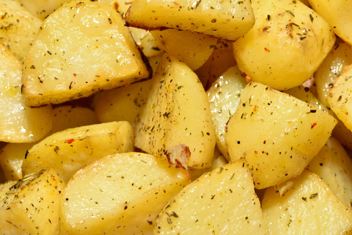 Appetizing and beautiful fried potatoes, yellow, with seasonings, close-up.