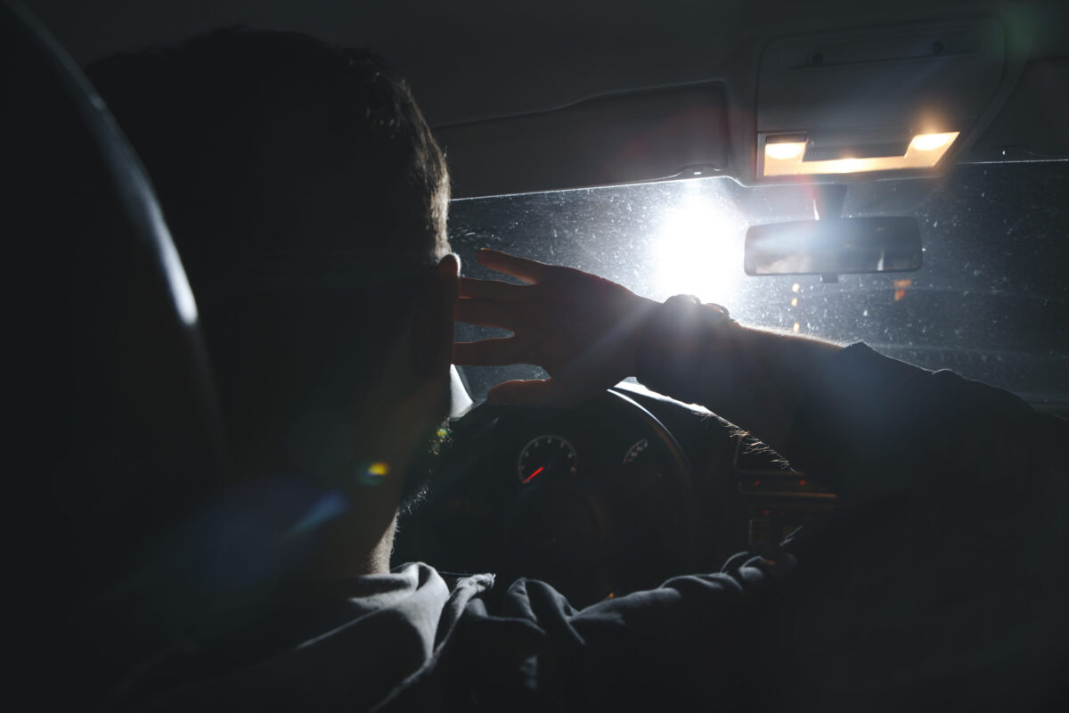 The man and woman drive a car in emergency situation. evening night time