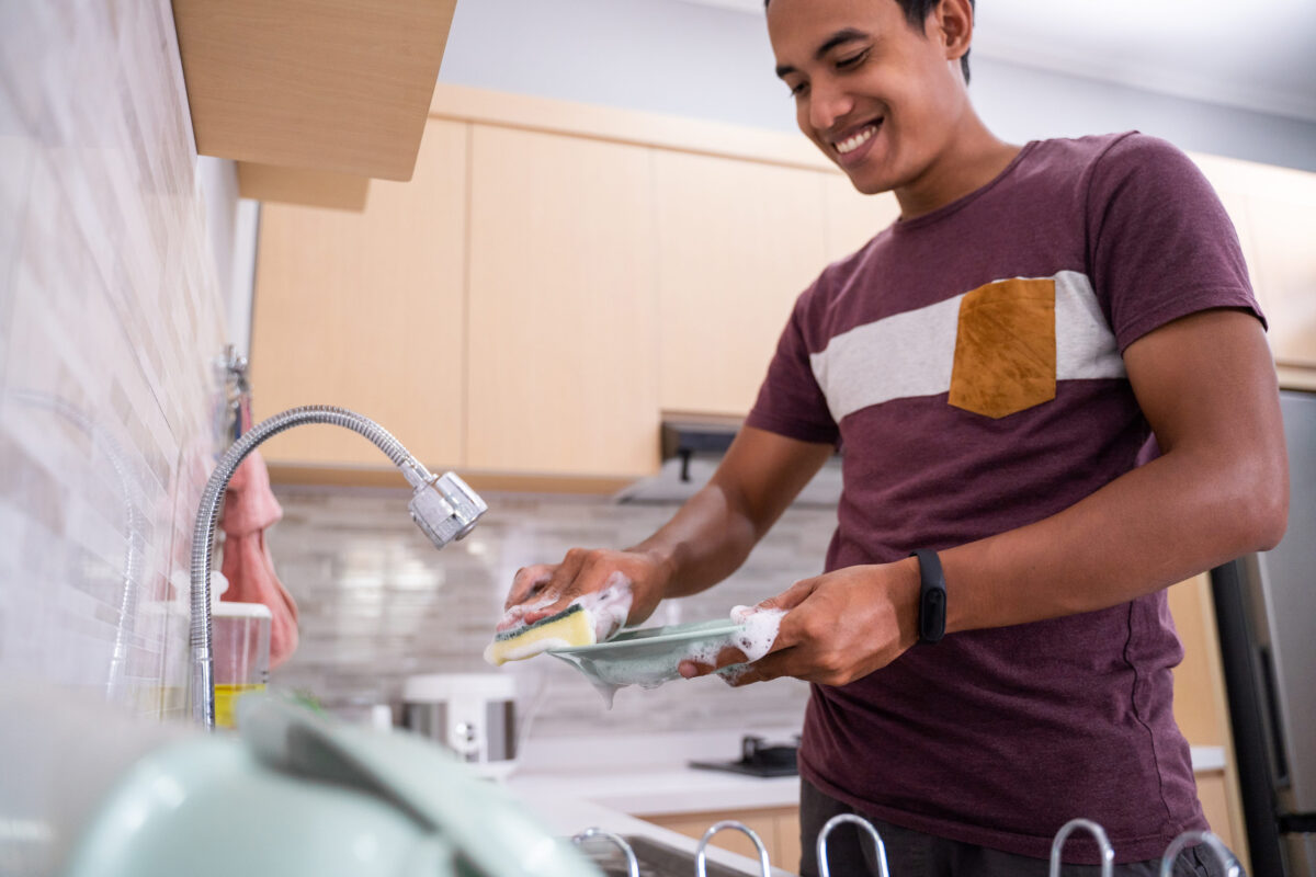 husband washing dish in the kitchen sink