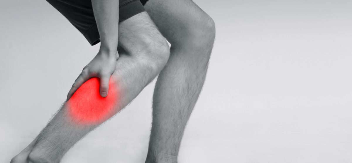 Calf leg pain, man holding sore and painful muscle, sprain or cramp ache, panorama with free space