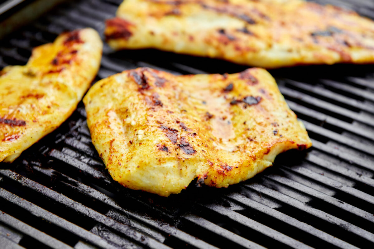 Grilled pike fillet on the gas grill. Grilled seafood. Barbecue fish. Copy space. Healthy food.