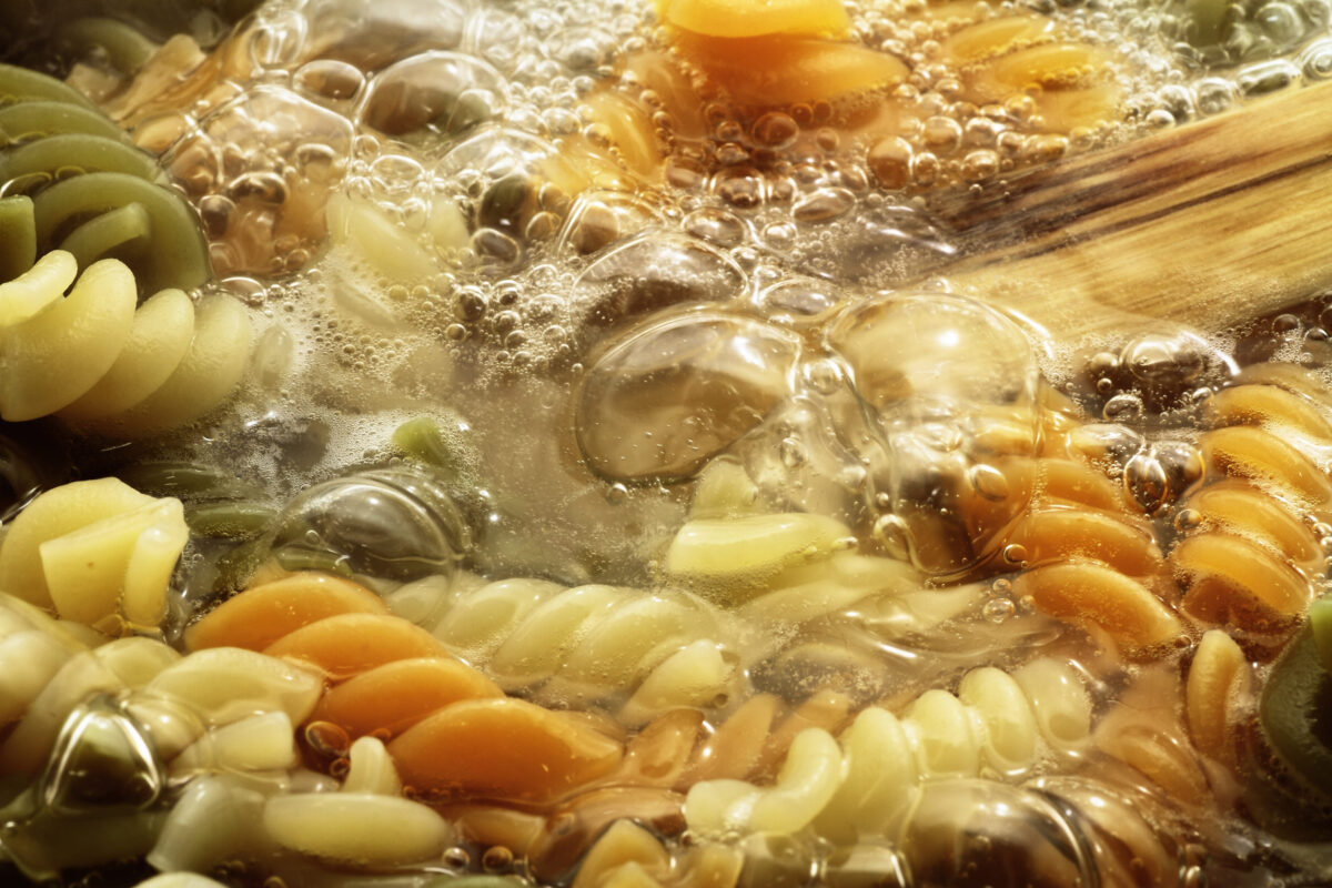 spiral pasta in boiling hot water Close