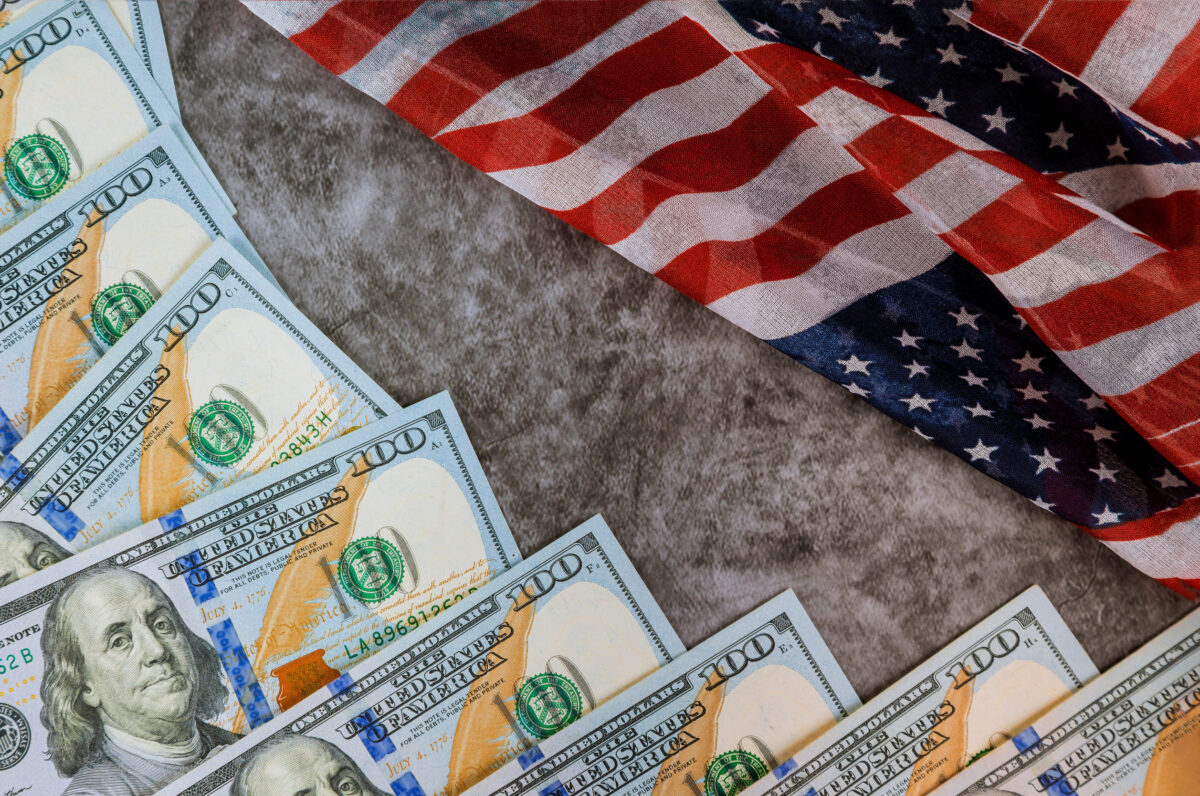 8 Recession Red Flags That Should Worry Americans Right Now 1 American flag and banknotes 100 USA dollar bill in the USA financial sector