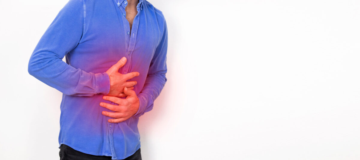 Young man having painful stomach ache, gastritis or abdomen bloating, isolated background. for health and hospital