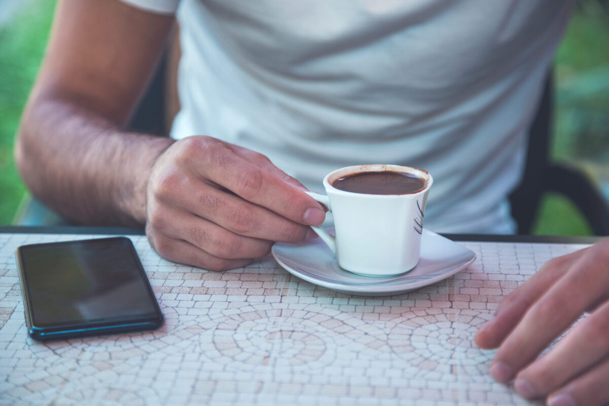 10 Brutal Mistakes That Can Ruin Your Medical Appointment 1 man hand coffee with phone in cafe