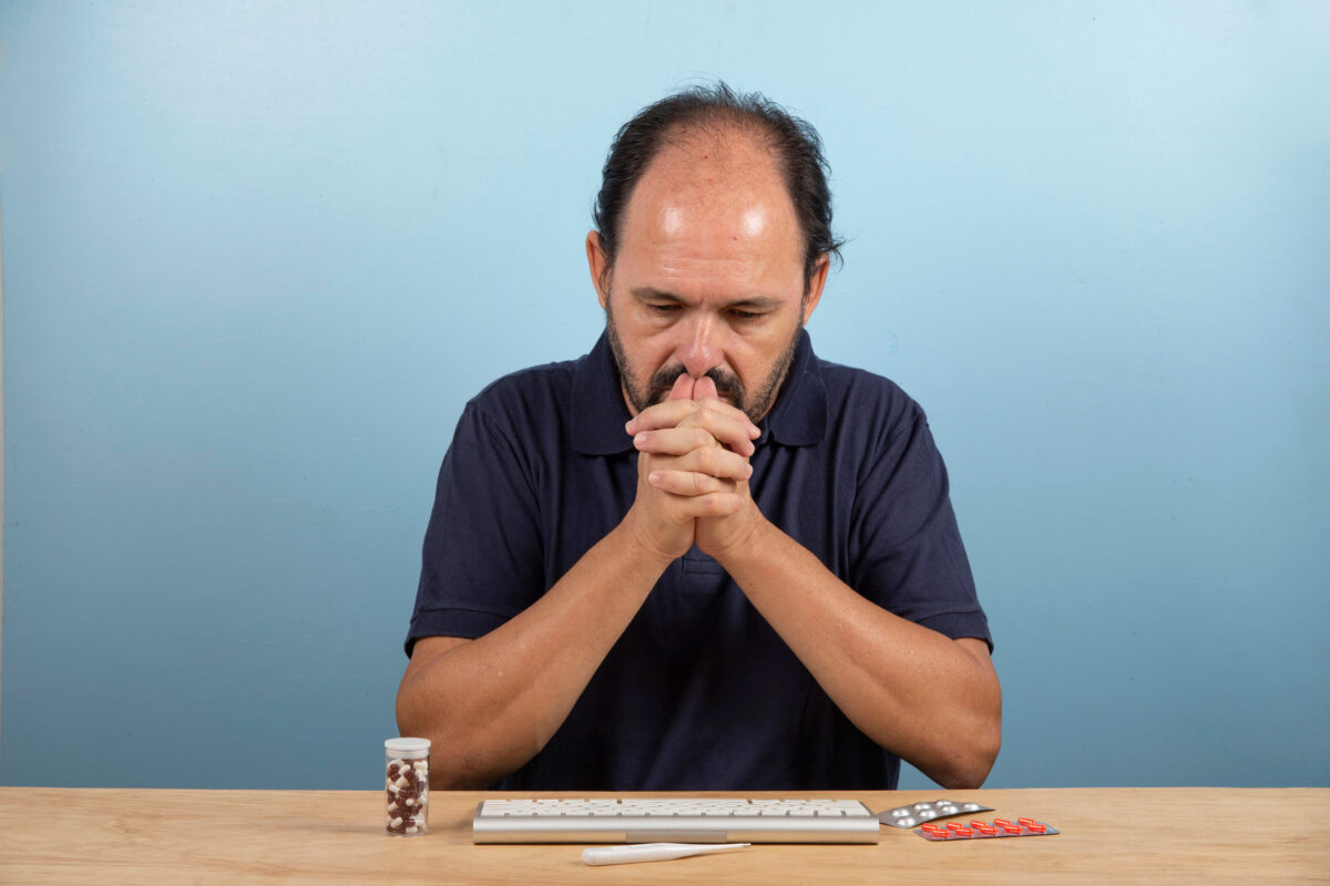 Patient praying that drugs will improve his illness.