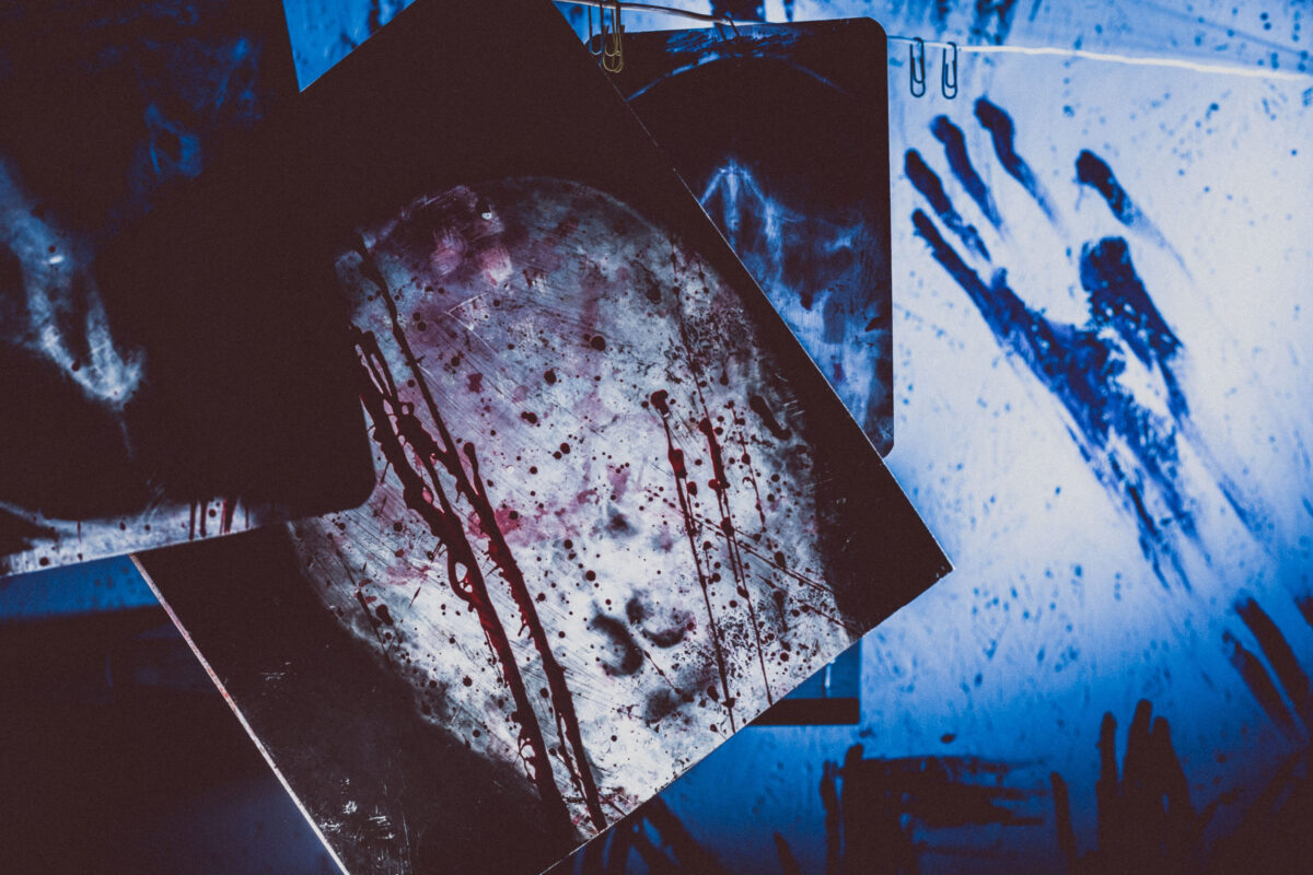 Bloody x-rays hanging on a rope in a dark room. Terrible room doctor maniac or killer.