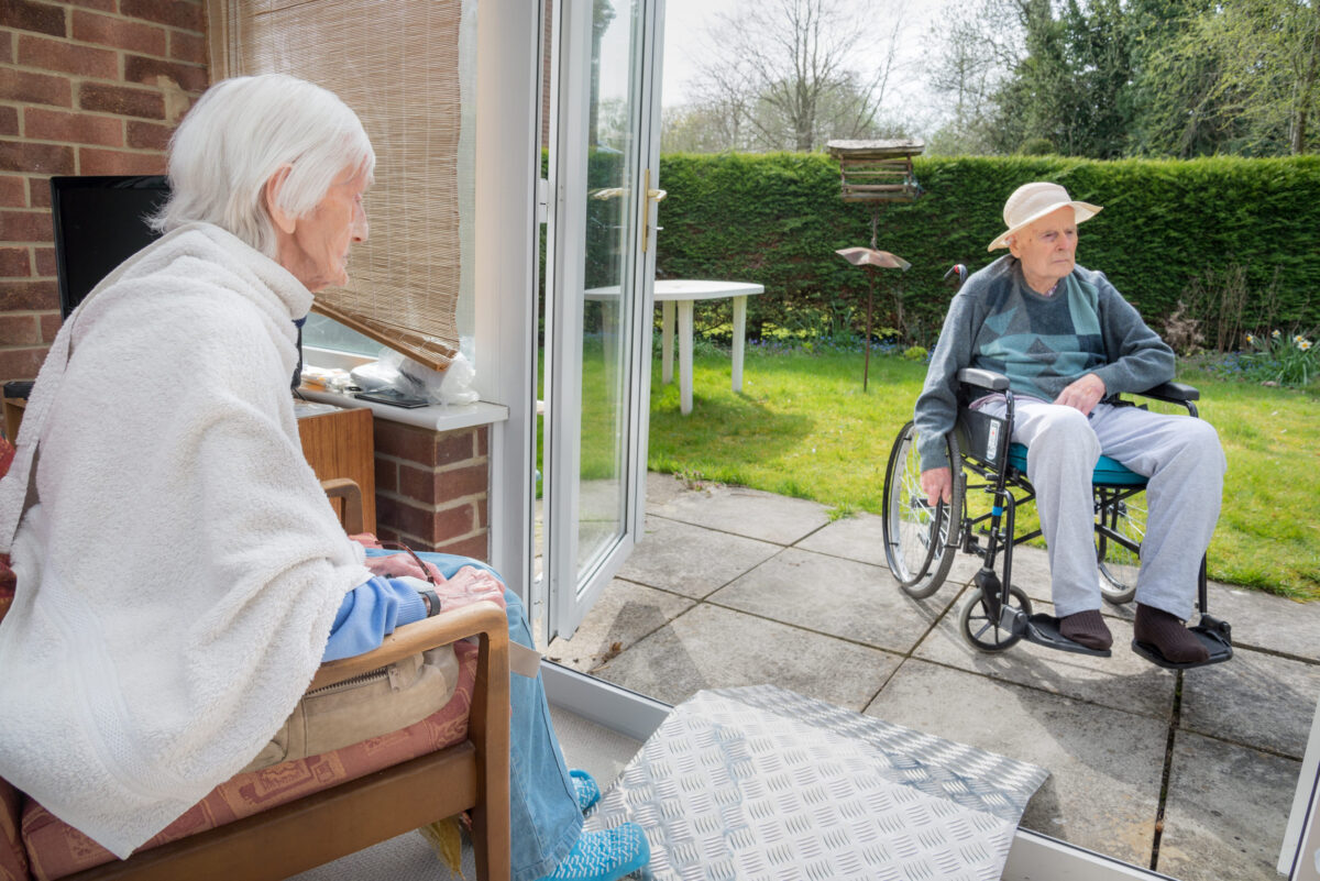 During Covoid 19 lockdown,at least they can sit in their back yard.Husband sits in wheelchair in the sun and wife sitting in the consevatory.Both in their 90s.