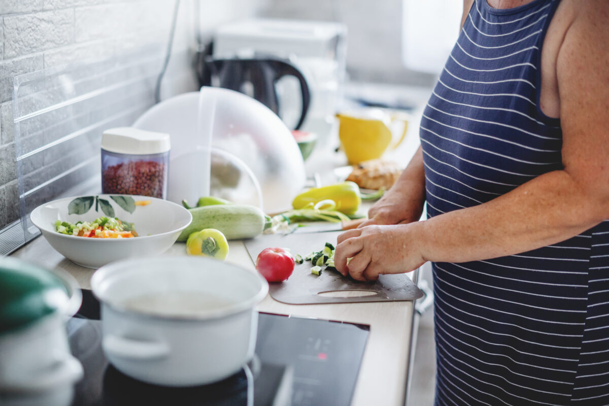 Woman cooking vegetables in the kitchen. Home cooking concept