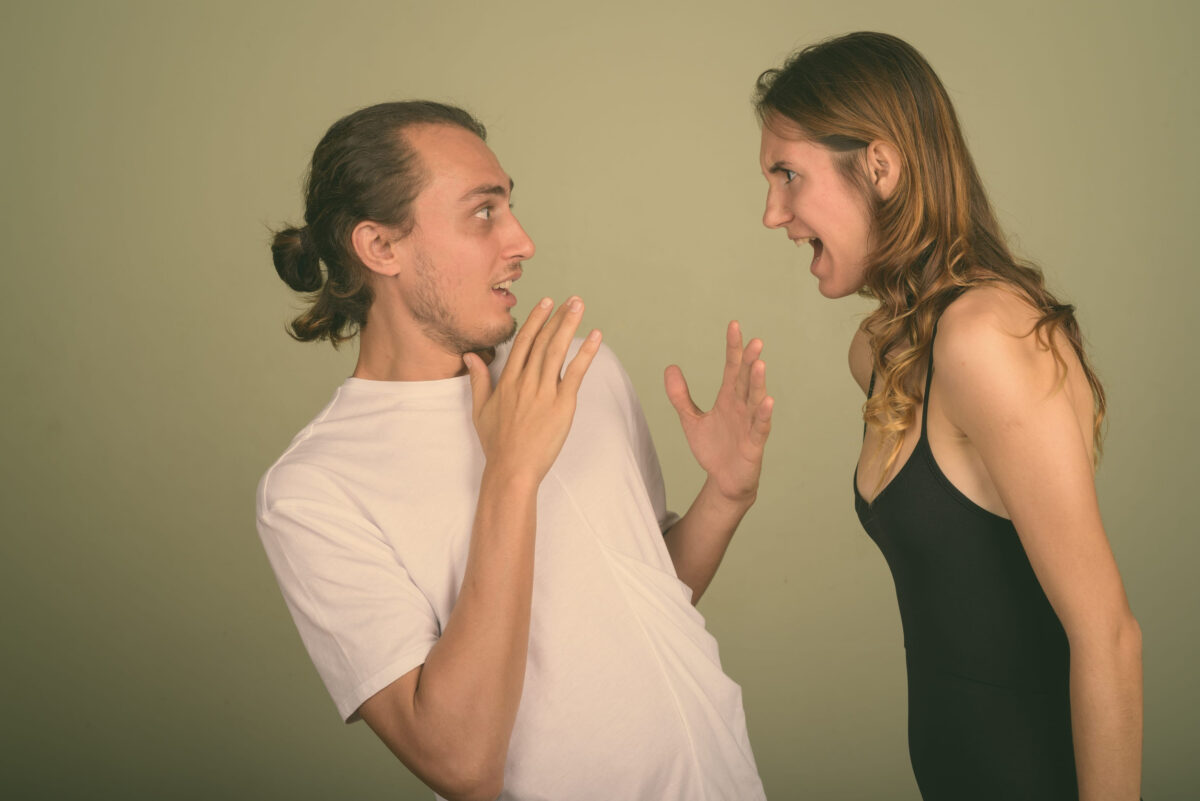 Young handsome man and young beautiful woman together against colored background