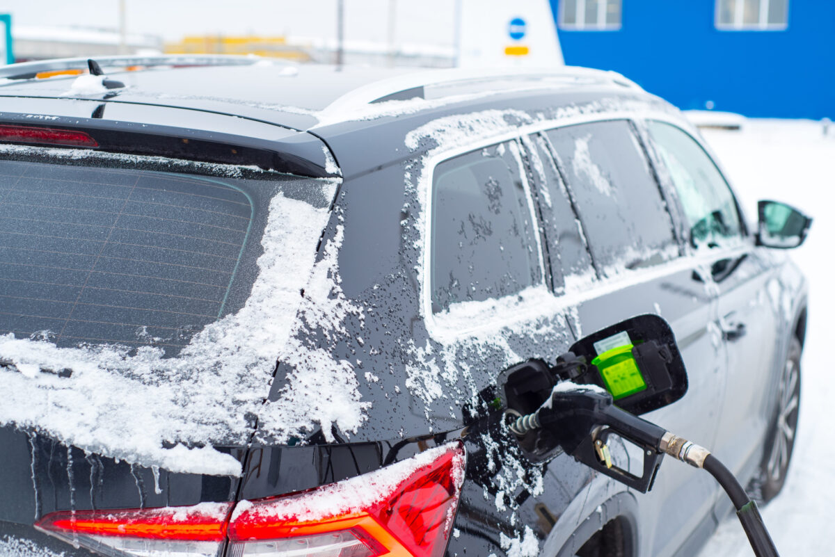Car refueling in winter close-up,