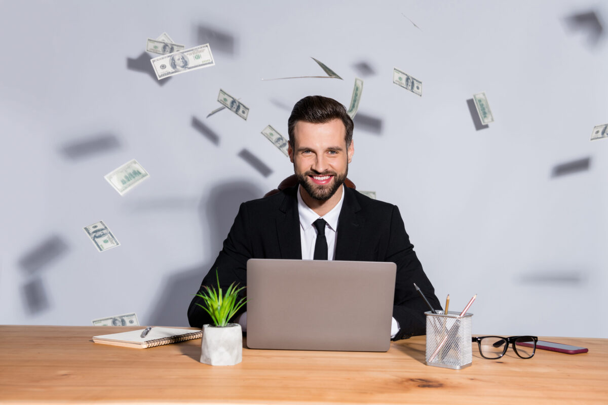 9 Financial Secrets That Can Break Trust Between Couples 3 Photo of macho business guy notebook table bucks american falling toothy smiling rich chief success startup income wear blazer shirt tie suit sit chair isolated grey background