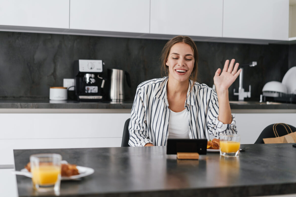 9 Breakfast Mistakes That Can Wreck Your Whole Morning 1 Young beautiful caucasian woman waving at cellphone while having breakfast at home