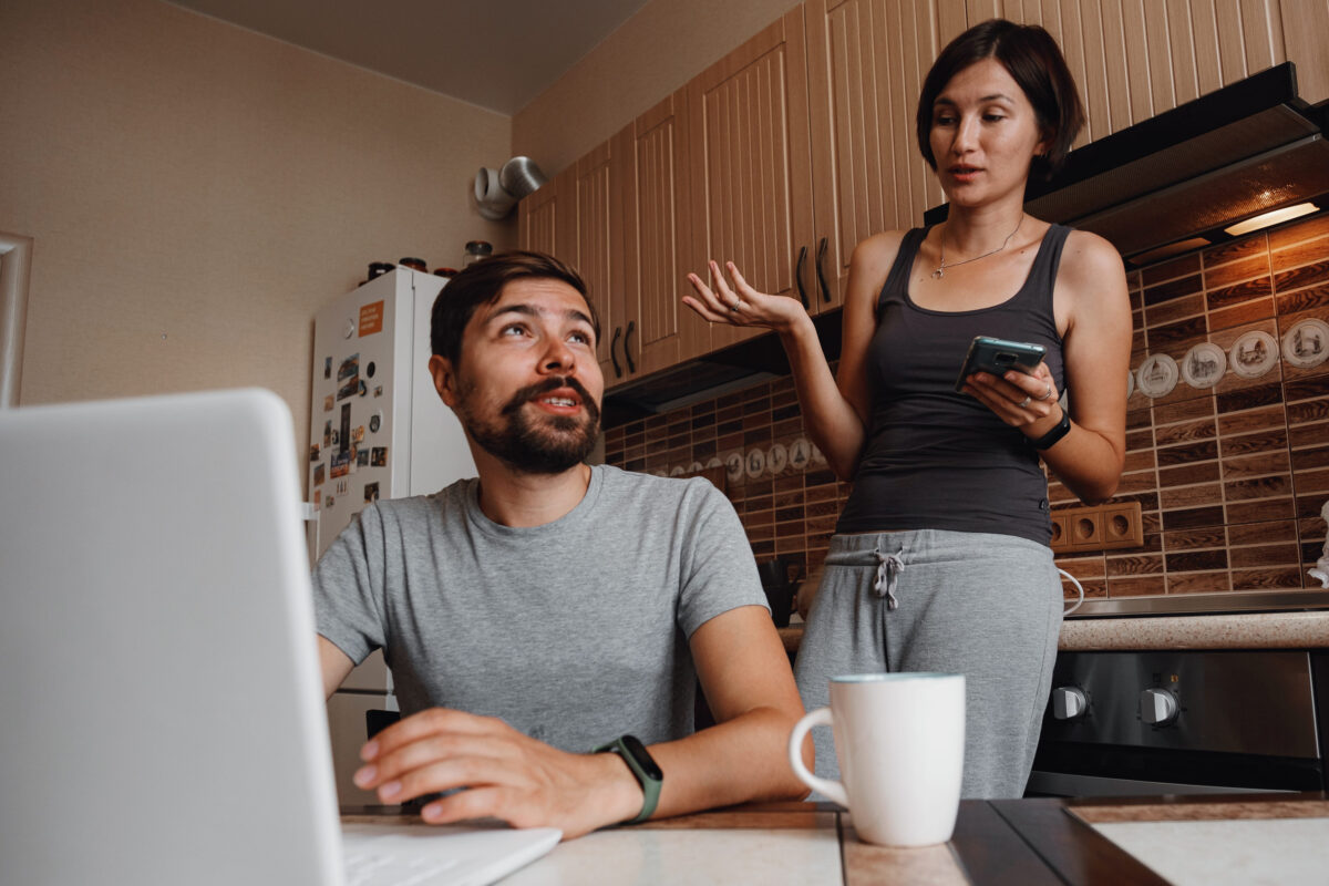7 Things That Can Destroy a Marriage or Long-Term Relationship, and How to Avoid Them 4 Young couple using laptop and smartphone in the kitchen, smiling man working online at home, family morning lifestyle with gadgets or devices addiction concept. readings news