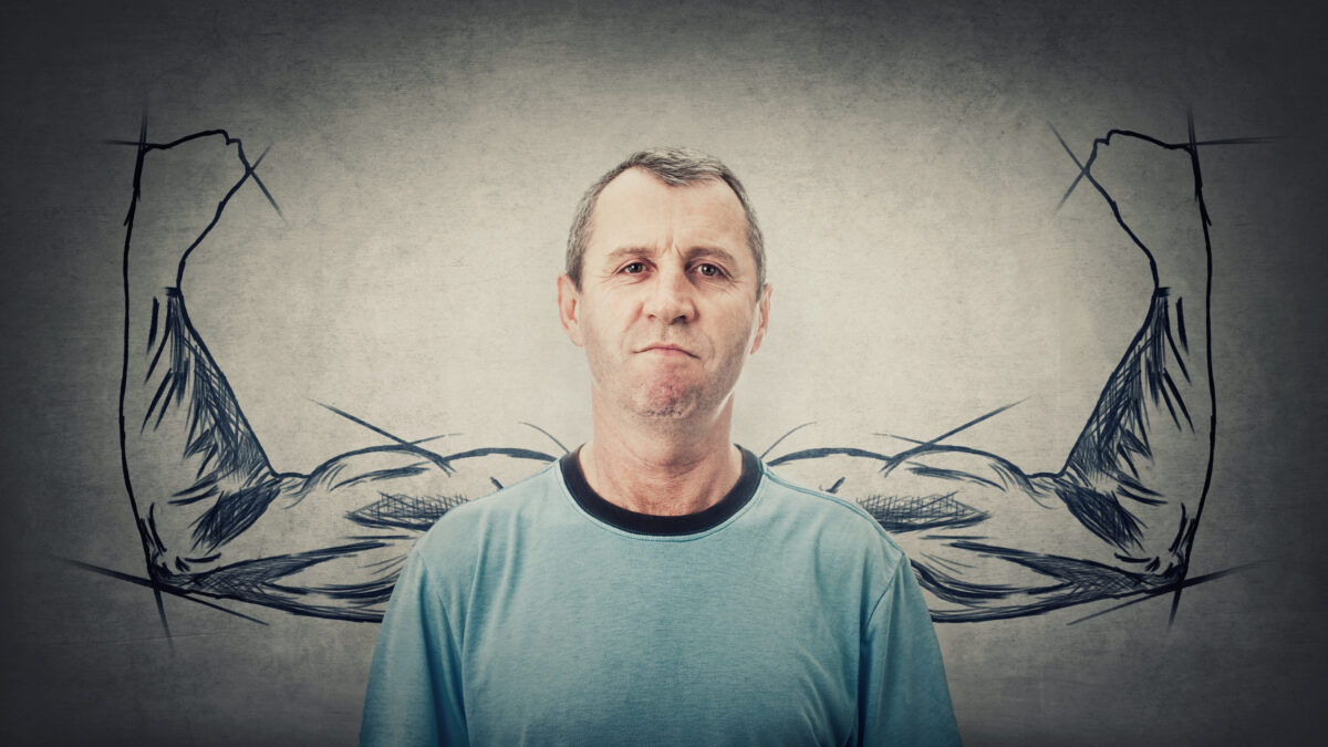 Confident middle age man has no fears. Powerful senior male with biceps, muscular arms behind his back shows the inner strength. Super powers metaphor. Angry adult reacting annoyed