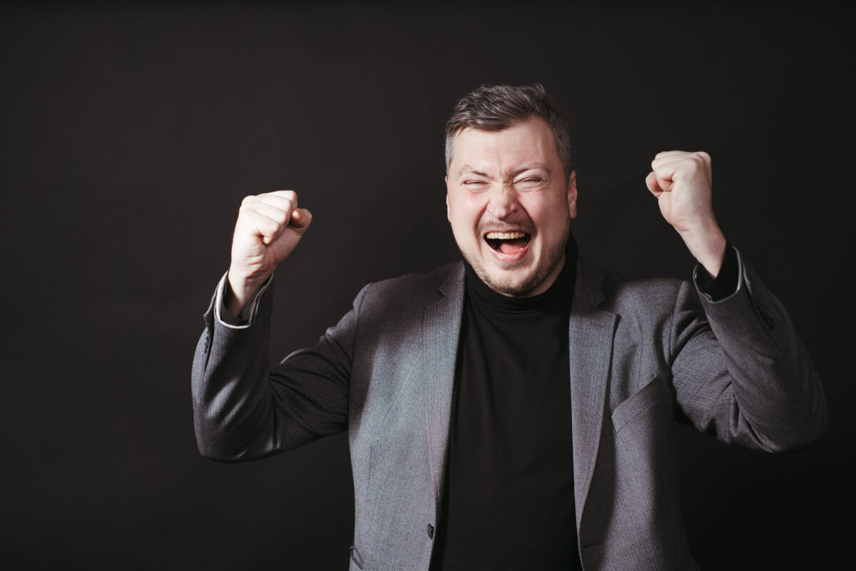 Businessman celebrating making winner gesture