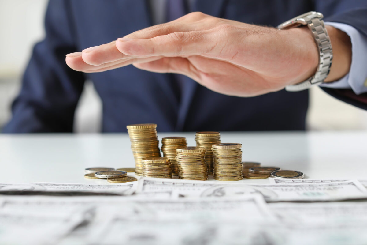 Male bank manager with money on table, closeup