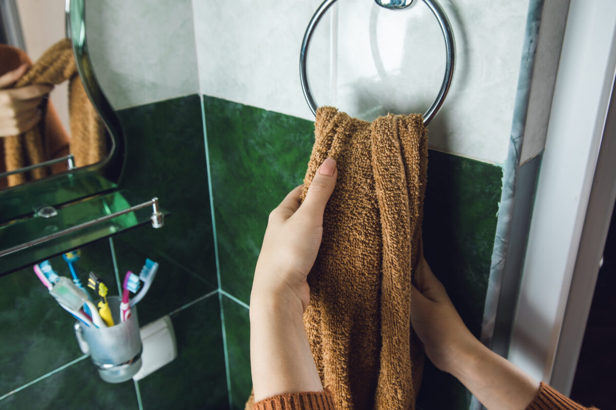 woman dry hands with a towel in the bathroom