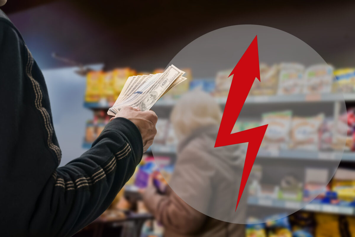 man holding dollars and arrow lightning hazard symbol