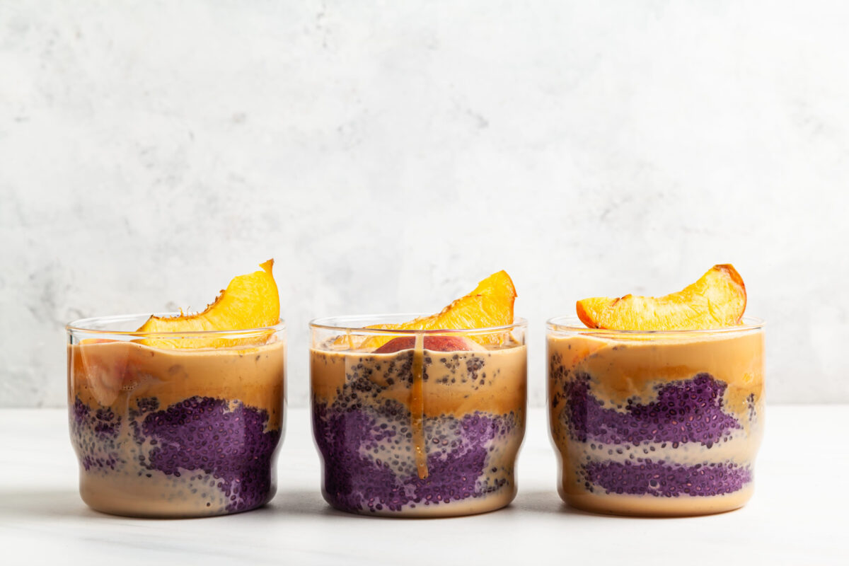 8 Reasons Why DIY Smoothies Are Destroying Your Waistline 4 Blueberry chia pudding with caramel and peaches in glass jars on a white table.