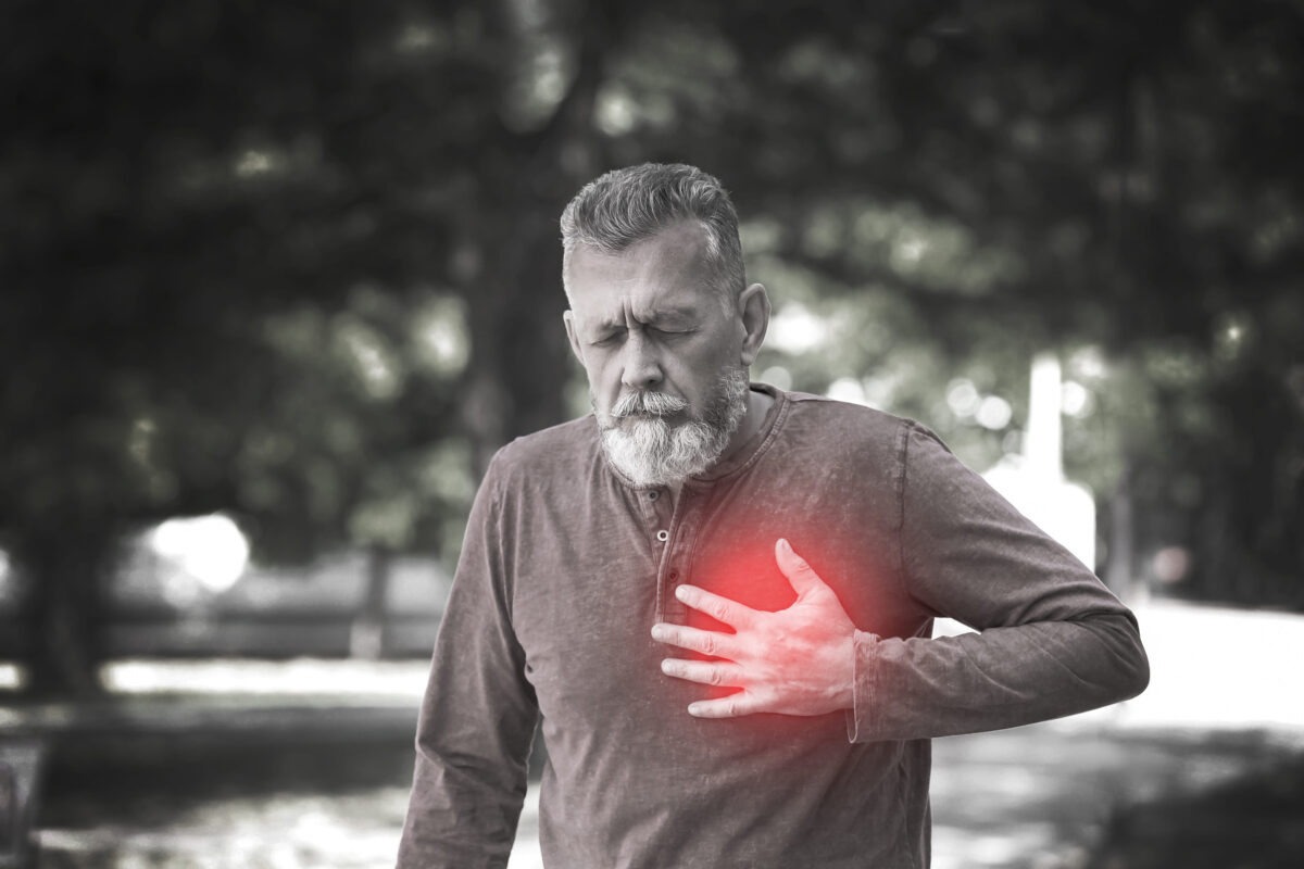 Mature man having heart attack in park