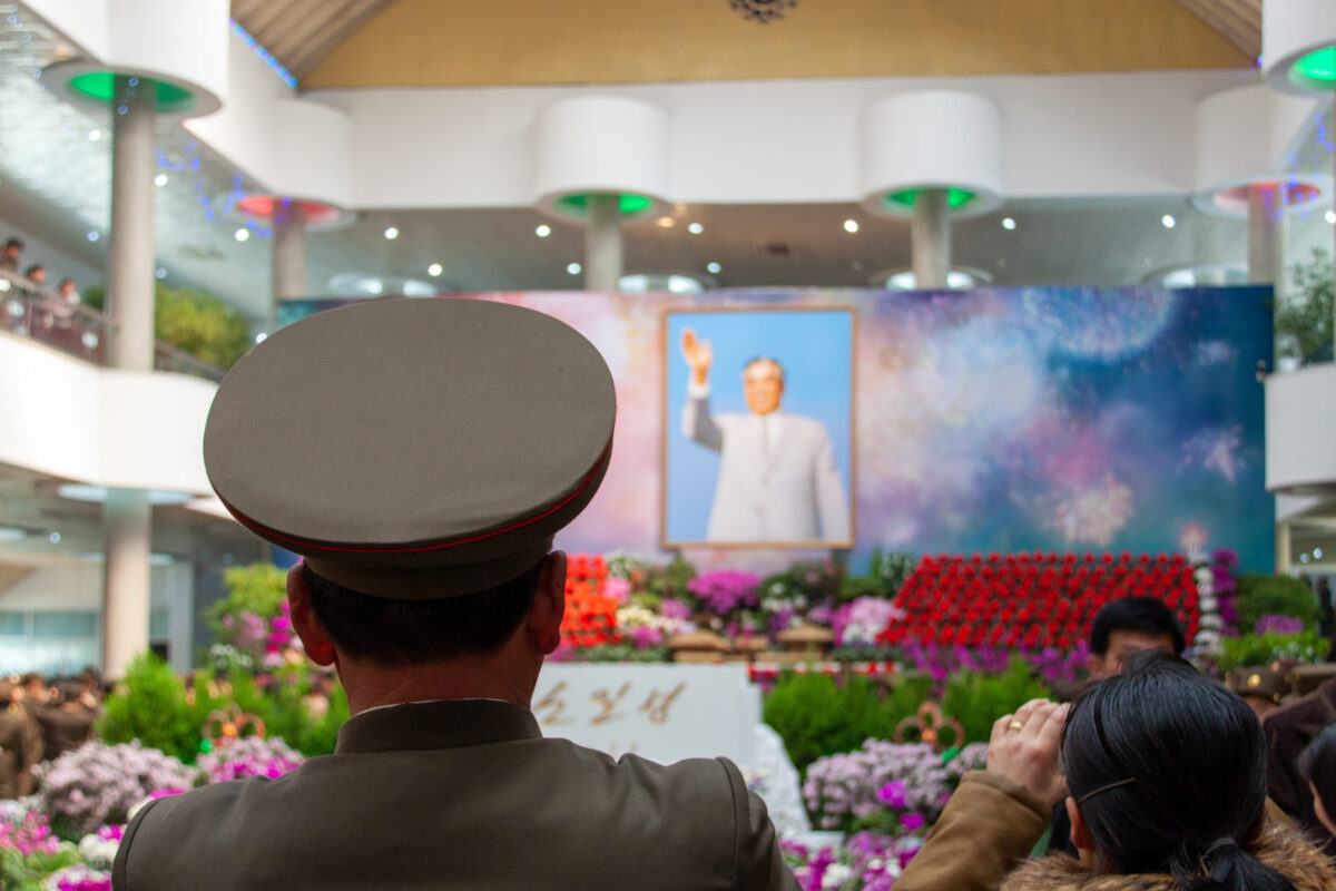 8 Leaders Who Wanted Worship, Not Respect 3 Pyongyang, North Korea - Apr 16, 2010: Back view of North Korean soldiers staring at Kim Il Sung portrait