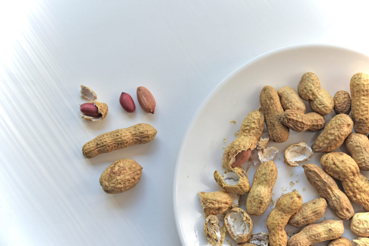 Nuts peanuts in a shell on a white plate