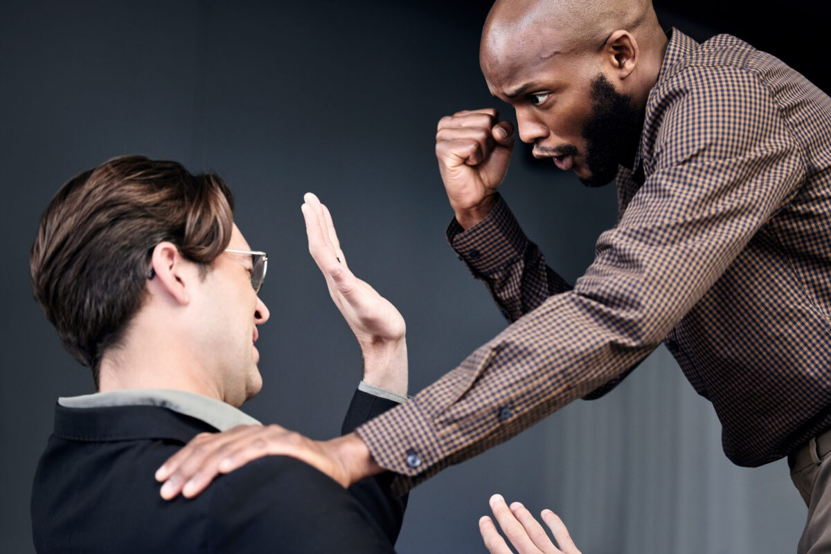 Things have turned ugly between them. Shot of two businessmen fighting in an office.