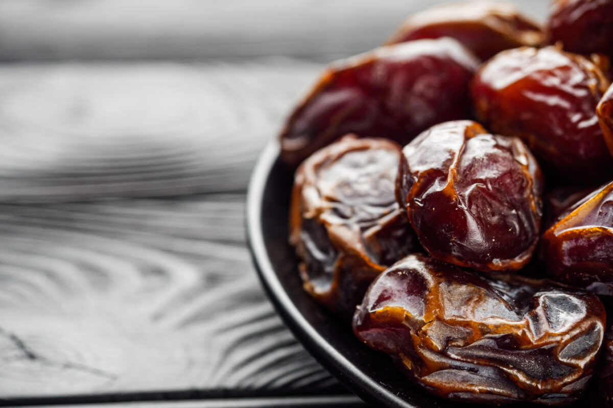 juicy royal dates on a black wooden rustic background.