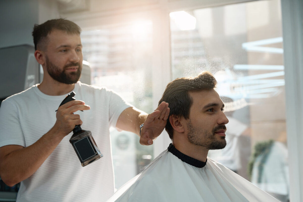 The Most Attractive Features People Notice First And Why They Matter 6 Qualified barber applying spray to client hair
