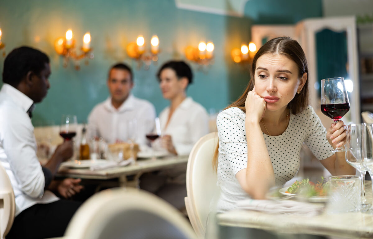 Sad lady at the restaurant table