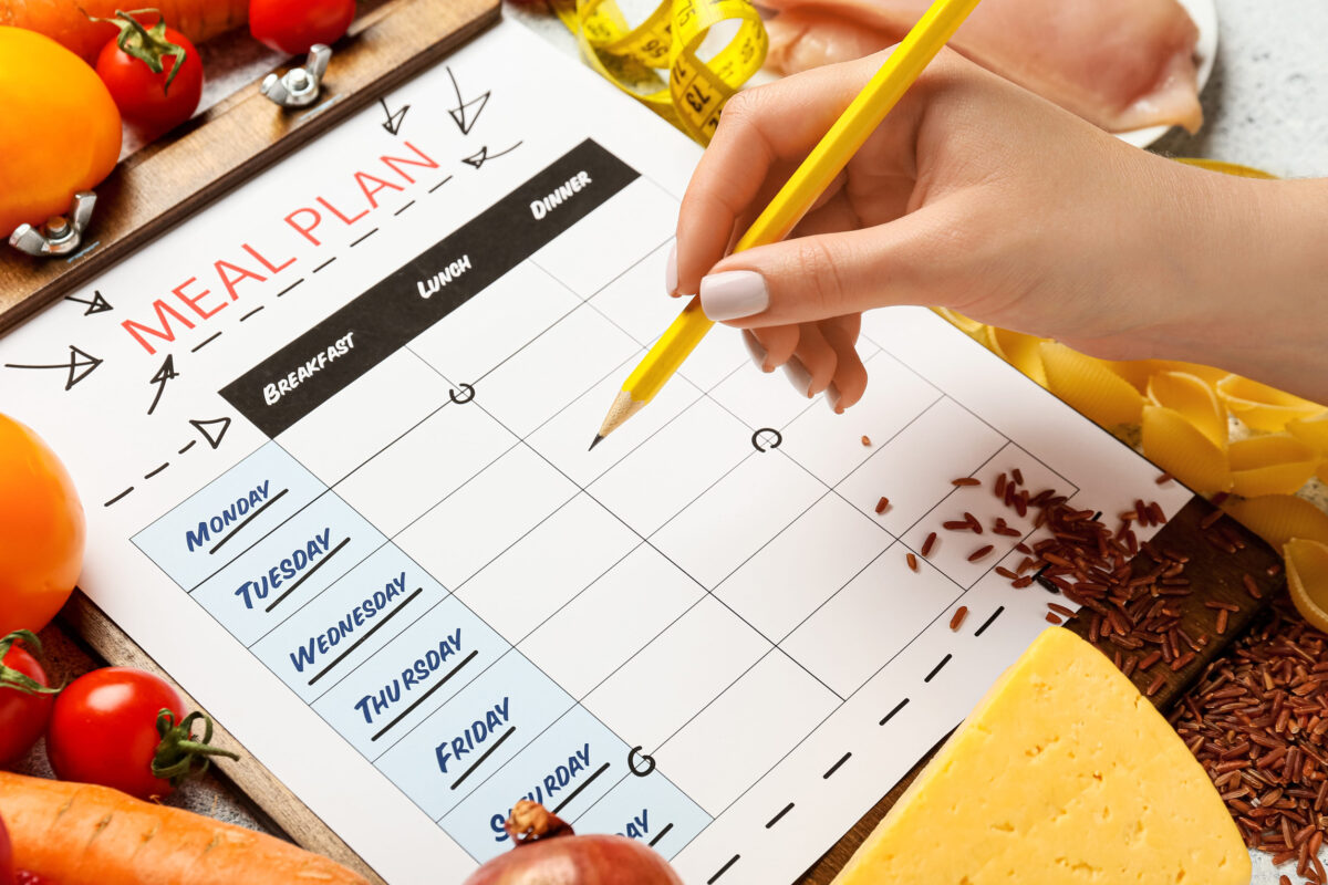 10 Grocery Shopping Methods That’ll Save You Time and Money 2 Woman making meal plan on table, closeup