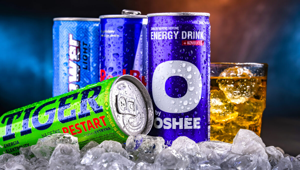 POZNAN, POL - NOV 25, 2022: Cans of popular global energy drinks, beverages containing stimulant drugs and marketed as providing mental and physical stimulation