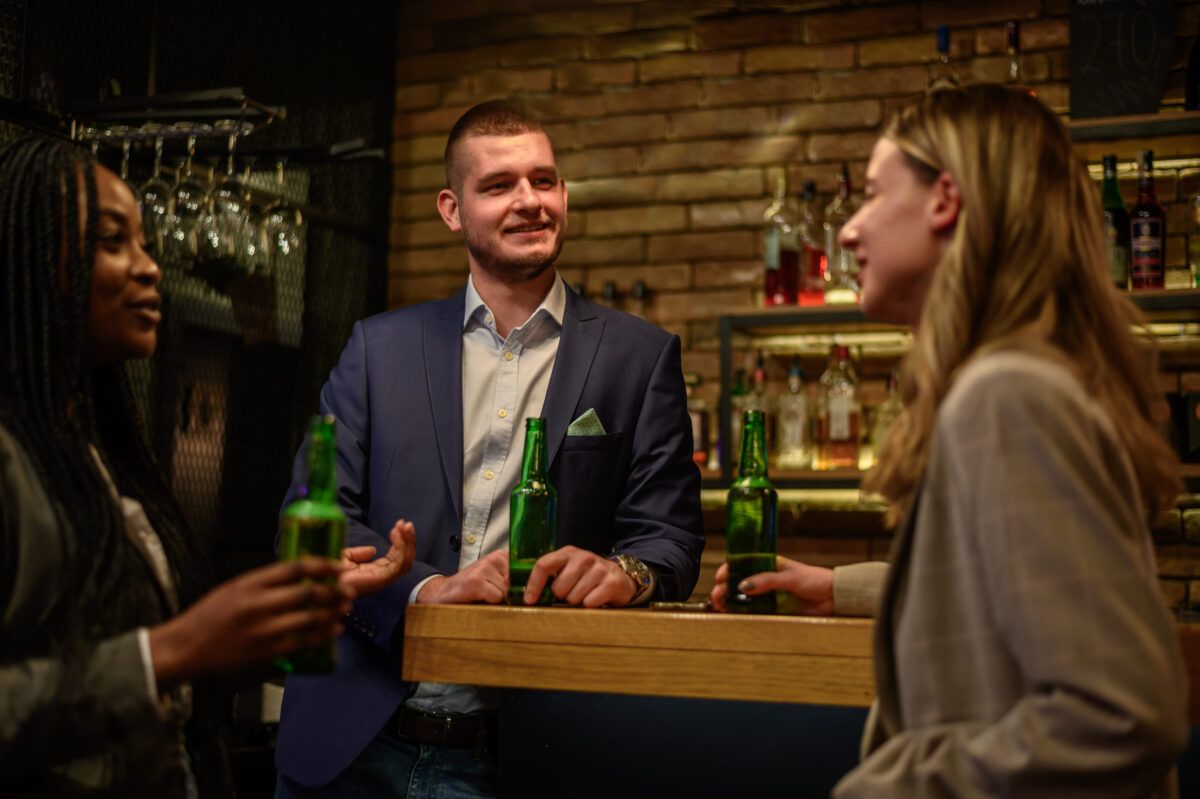 8 Things You Should Never Say to a Police Officer 2 Cheerful colleagues drinking beer in the bar together after work