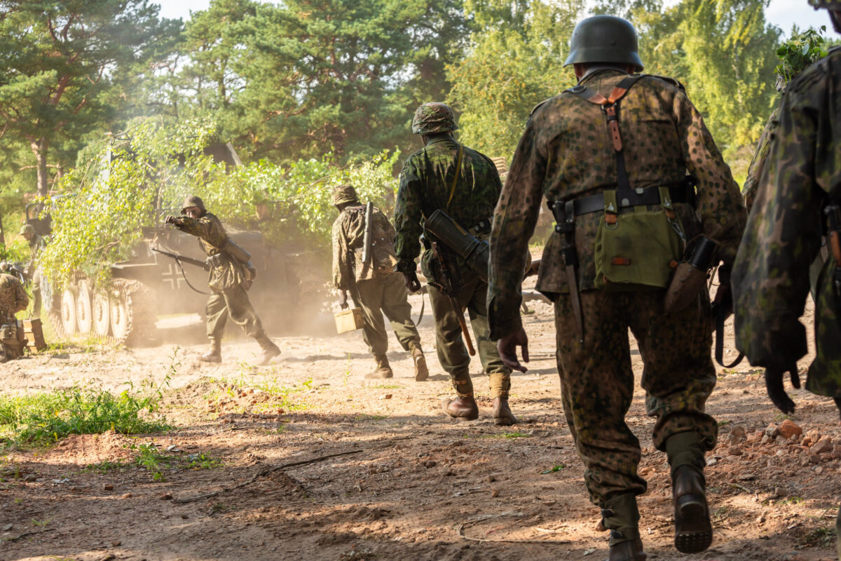 Hel, Pomerania, Poland- August 24, 2023: Reconstruction of battle from the Second World War. Wehrmacht infantry soldiers during combat.
